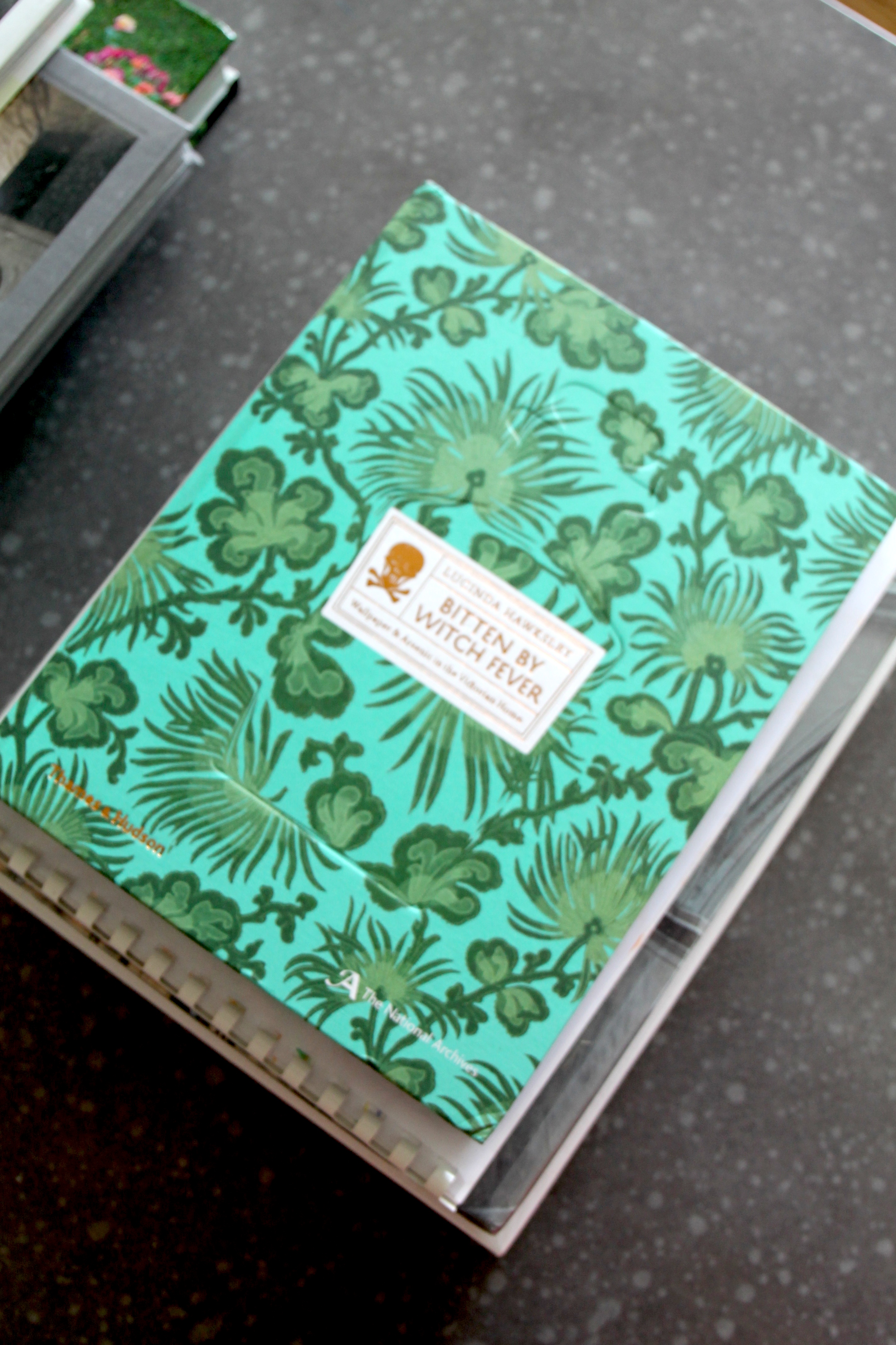 Coffee table book chosen for its pattern and color, which fits with the room's theme. Design wise that is.