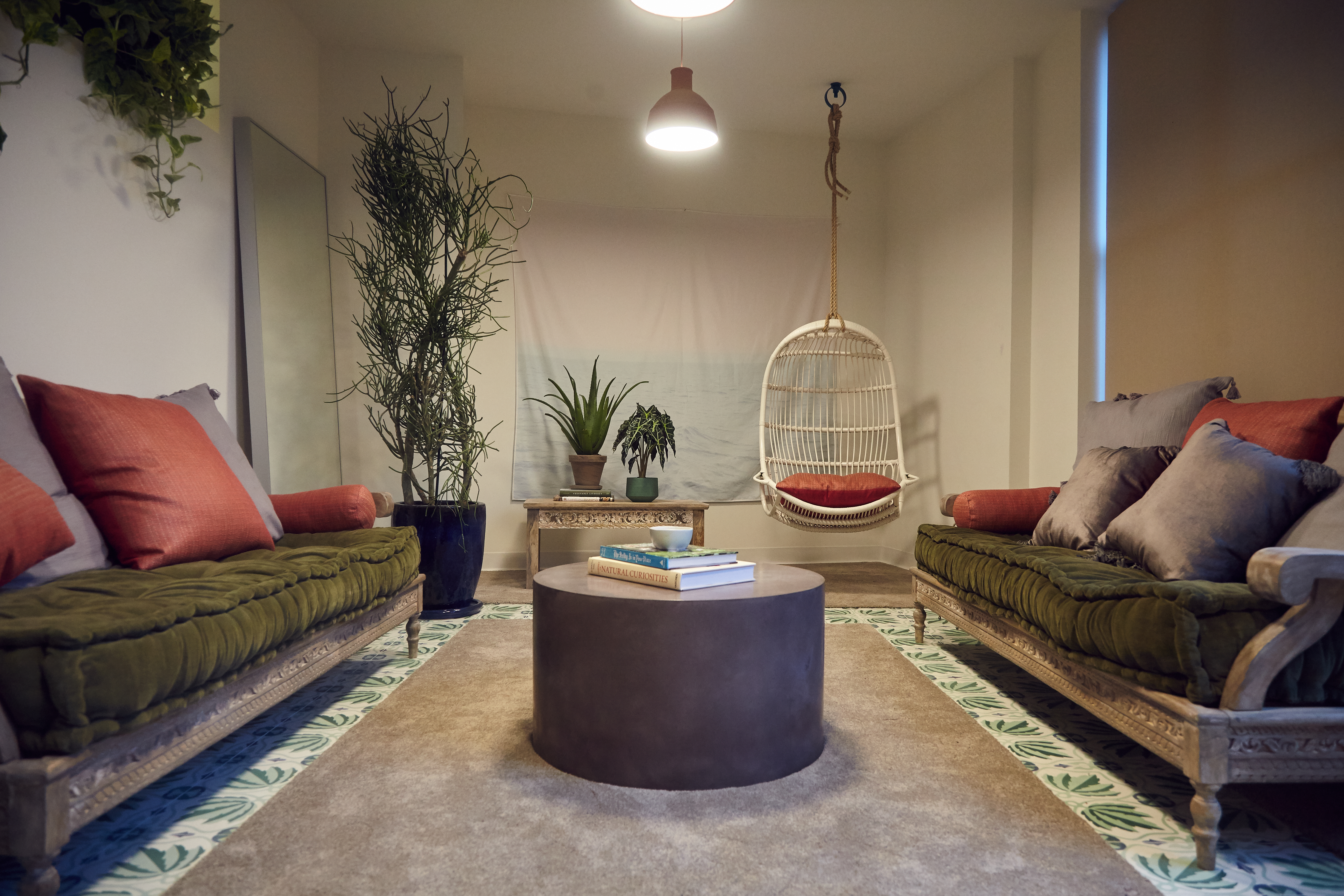 A playful approach to an office gathering place through zozy furnishings and bamboo swing chair.