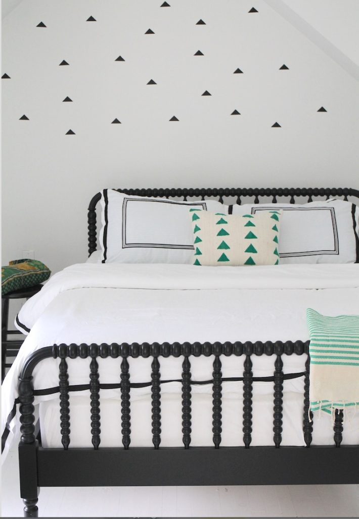 Choosing one strong accent color with a geometric pattern can set a bed's theme.